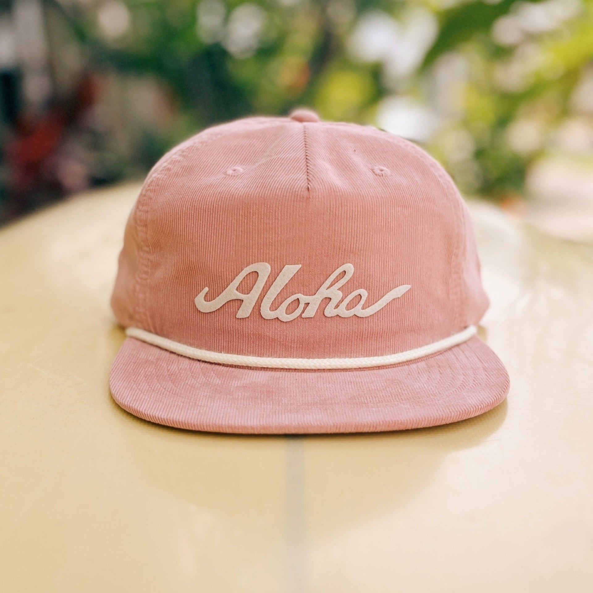 Throwback Hawaii corduroy cap with aloha script felt applique by Nick Kuchar. Available in four colors, one size fits all.
