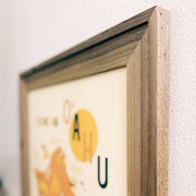 Framed artwork with a wooden frame on a white wall