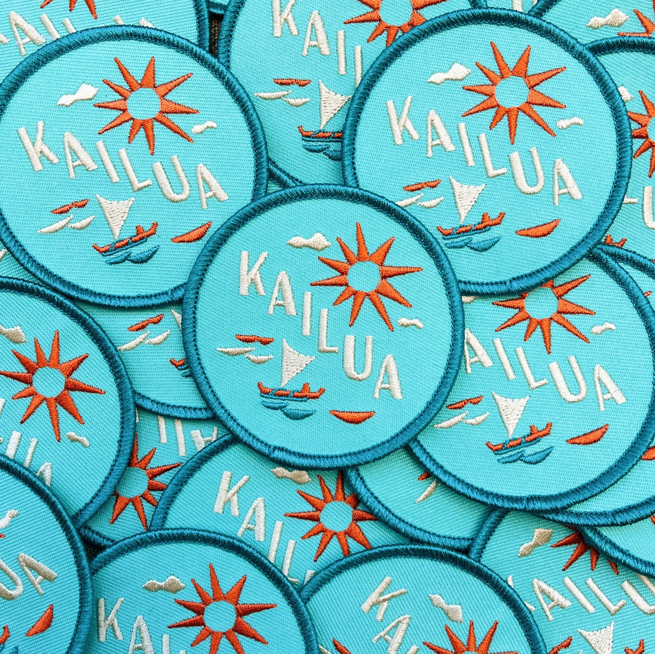 2.75" embroidered patch featuring a sailing canoe and sunshine over Kailua Town oahu, with vibrant colors. Iron-on backing.