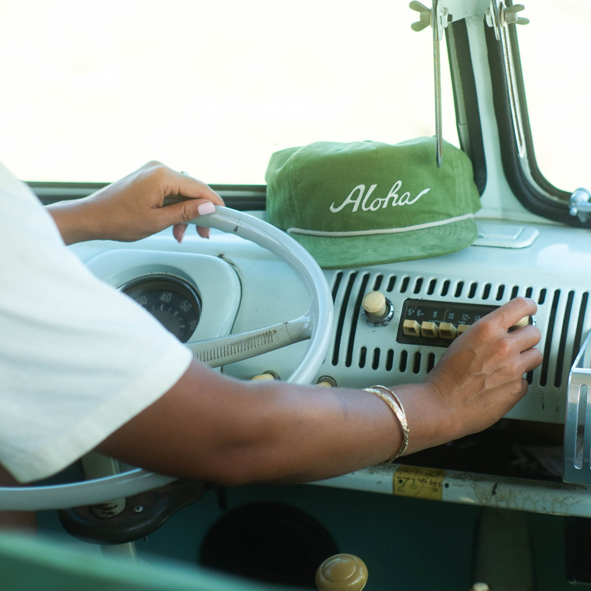 aloha hat sitting on dashboard of vintage van
