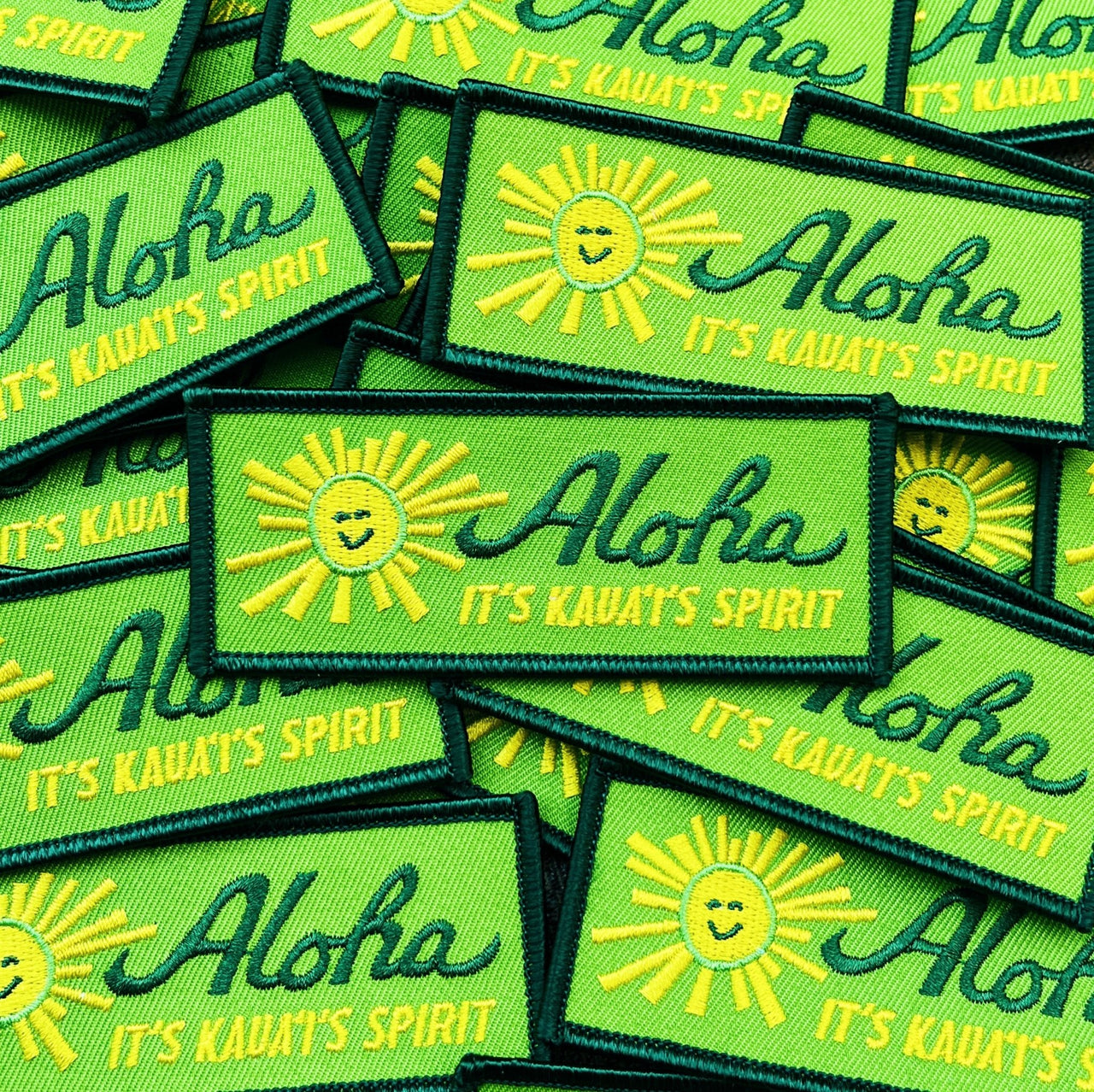 3.75"x1.5" embroidered green patch featuring Aloha Its Kaua‘i's spirit, South Shore, with vibrant colors. Iron-on backing.