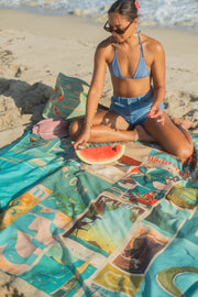 woman having watermelon picnic in hawaii at the beach