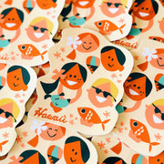 Sticker design with people, kids and fish, featuring the word 'Hawaii'.