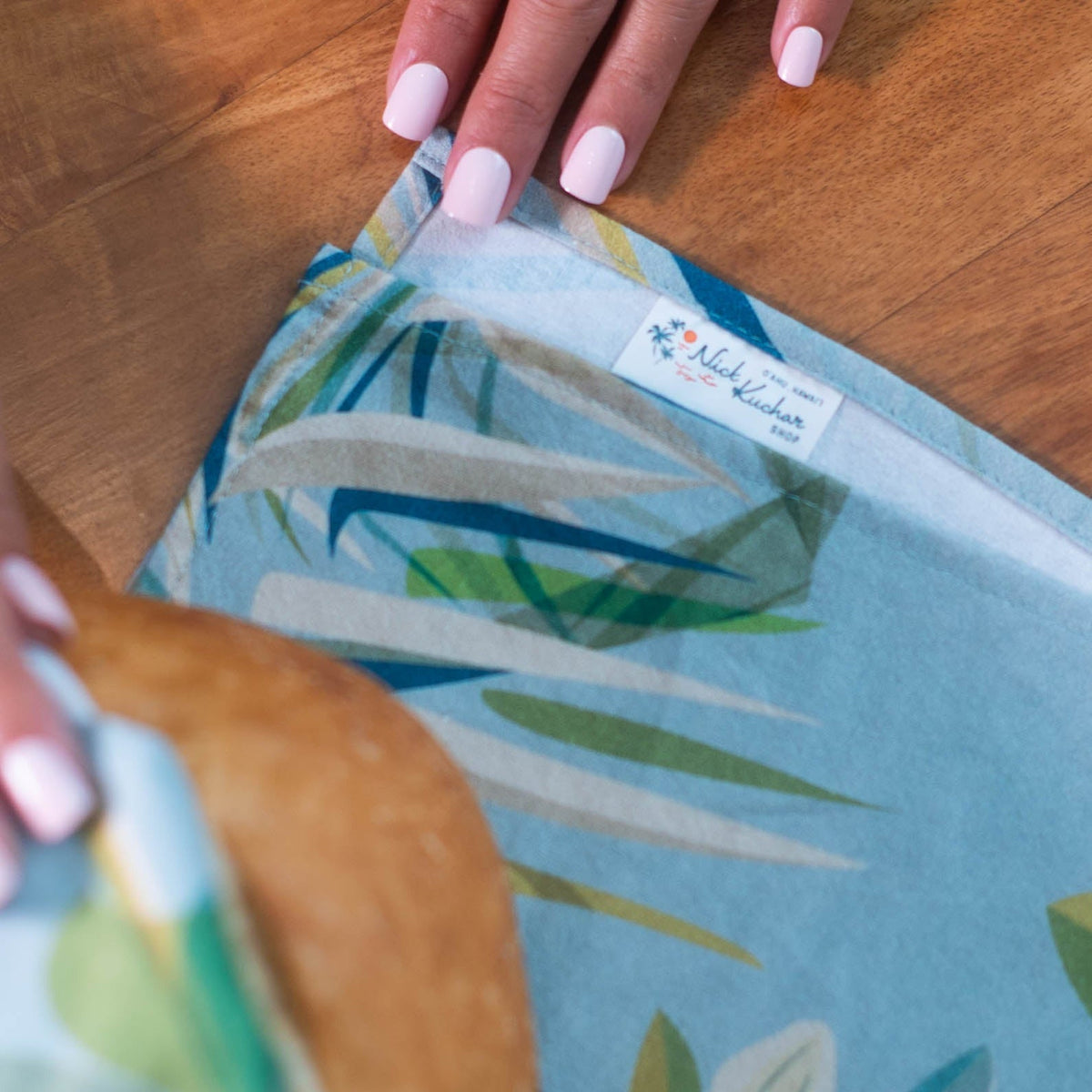 aqua surf kitchen tea towel showing logo label