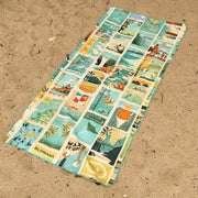 Colorful beach mat with illustrated designs on a sandy surface