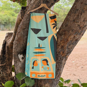 Towel with a tropical design hanging on a tree branch outdoors