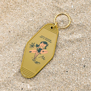 Keychain with vintage-style design on a sandy background