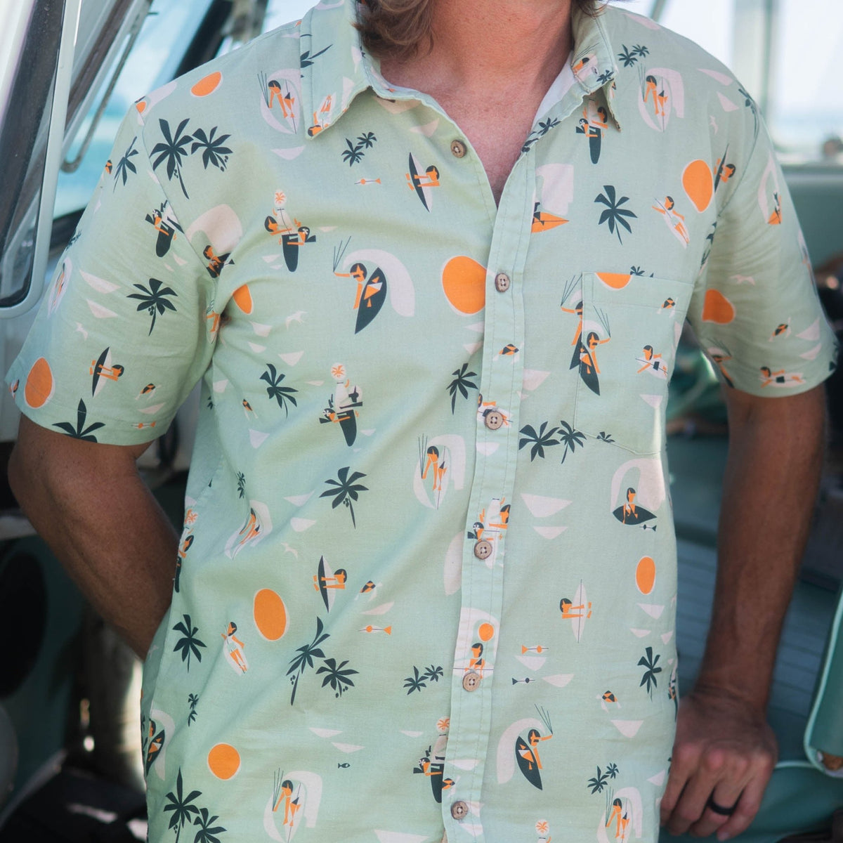 man wearing button up shirt at the beach